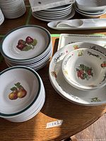 Stacks of fruit motif bowls, pasta motif pieces, rectangular platter, spoon rest