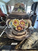 Tureen assembled with lid on underplate showing full floral decoration