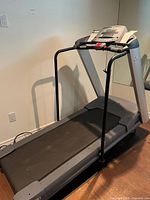 Full view of treadmill showing running deck and frame