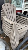 Stacked view of multiple gray resin Adirondack chairs