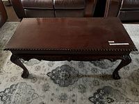 top view of dark mahogany coffee table on rug