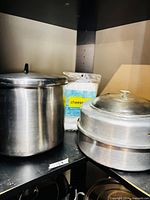 stock pot and steamer set on shelf