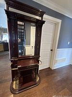 Full view of mahogany hall tree showing mirror, drawer, hooks, umbrella rail