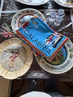 Group shot showing plates, shot glasses and folded scarves from Calabria