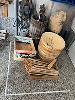 Group shot showing grape press, stack of bushel baskets, De Palma crate, Bricco Rocche crate with bundle of slats