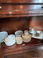 All pieces arranged on cabinet shelf