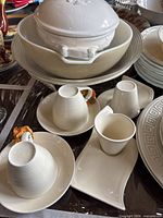overview of cups, saucers, tray, serving bowl and tureen