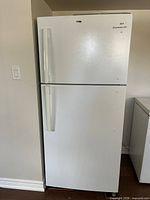 Full exterior view of white top-freezer refrigerator