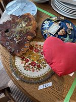 Group shot showing clock, doily, pillow, tray with magnets