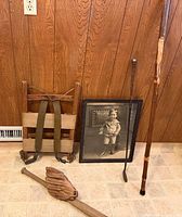Group shot showing basket, walking stick, golf iron, photo, bat, glove