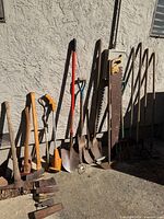Group shot of all garden tools leaning against wall