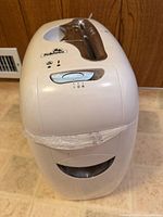 Front view showing shredder body, waste bin window and control panel