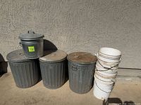 Group shot of three 20-gal galvanized cans with 5-gal bucket on top
