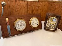 Front view of both items showing weather station gauges and mantel clock