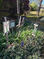 Overview of multiple garden stakes in flowerbed