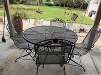 Full view of patio set showing round table and four chairs