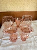 All eight pink Depression glass pieces displayed