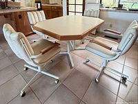 Overall view of table with four swivel chairs around it