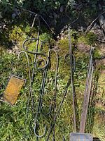 Group of hooks, rods and plate on grass