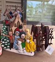 Caroler church scene and pair of reindeer