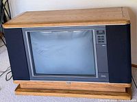 Front view of NEC KX-2750A console TV showing woodgrain cabinet and screen