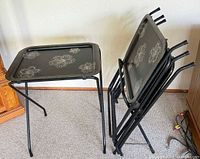 Set showing one tray on legs and remaining trays stacked in storage stand