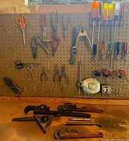 Pegboard view with pliers, snips, clamp, tape measure and screwdrivers