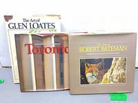 Front view of all three hardcover books showing titles and cover wear