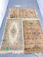 Overview of three small rugs laid out side by side