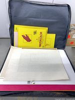 Open Nobel portfolio showing watercolour pads and papers