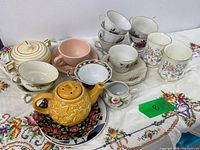 Full lot overview showing cups, saucers, teapot, sugar bowl and plates