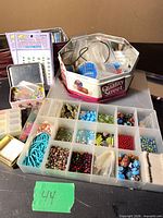 overall lot with organizer, tin, embellishment packs and bead cases