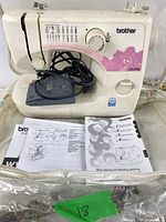 Brother LX-3125 sewing machine with foot pedal and manuals visible