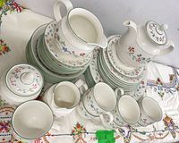 Full grouping of stacked plates, bowls, gravy boat, teapot, cups, creamer, sugar bowl showing pattern and counts