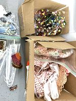 overview of boxes with flowers, pipe cleaners, crochet hat