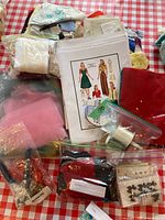 Overview of sewing pattern, fabric remnants, ribbons, tulle