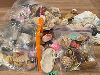 Bags with assorted doll shoes, socks, straw hats and baskets