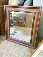 Full view of rectangular wall mirror against wall