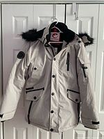 Front view of white Canada Weathergear winter coat displayed on hanger