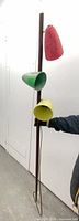Full view of lamp showing three coloured fiberglass shades on pole