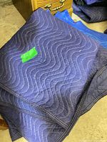 Stacked dark navy and royal blue quilted moving blankets