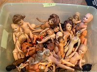 Plastic tote filled with nude hard plastic dolls