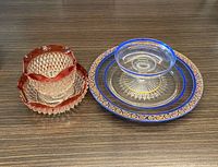 All four glass pieces: two red-rim bowls, blue plate, clear dip bowl
