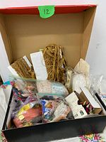Open box with assorted sewing notions visible