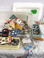 Overall view of lot showing boxes of buttons, patches, scissors and attachments