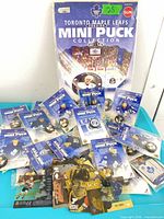 Group shot of sealed mini pucks, display sleeve, and loose trading cards