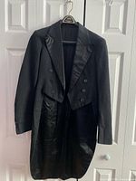 Front view of black tail jacket on hanger