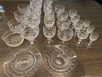 Full set of crystal stemware, bowls and plates on table