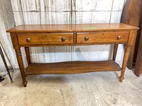 Front view of console showing two drawers and shelf