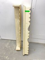 Front view showing both cornices, scalloped design and paint condition